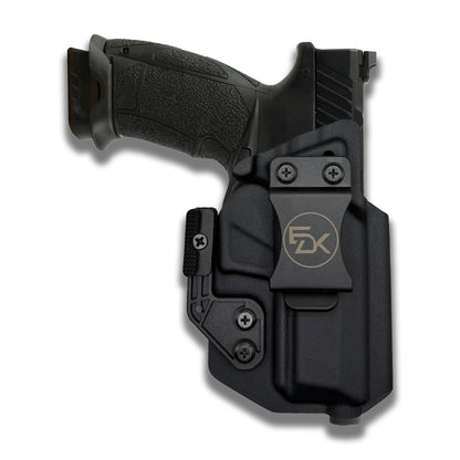 A black Kydex belt holster containing a black semi-automatic pistol, shown against a plain white background. The holster features a gold-toned '5K' logo on the front plate and is displayed at a three-quarter angle.